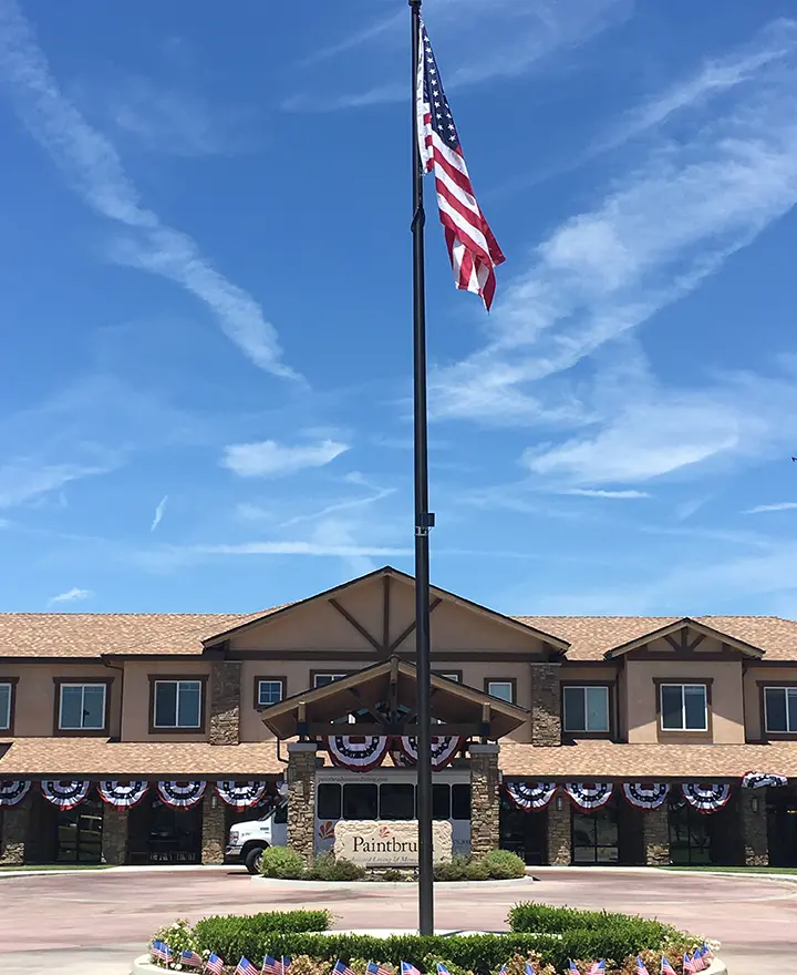 Paintbrush Assisted Living | Outside view of building with American flag
